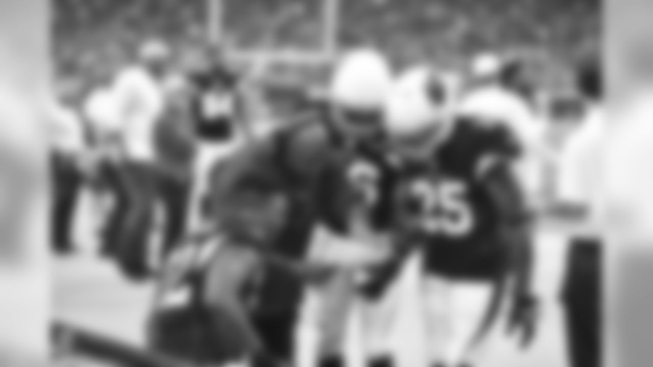 S Tony Jefferson (left), S Rashad Johnson (middle) and CB Jerraud Powers look at a play with cornerbacks coach Kevin Ross