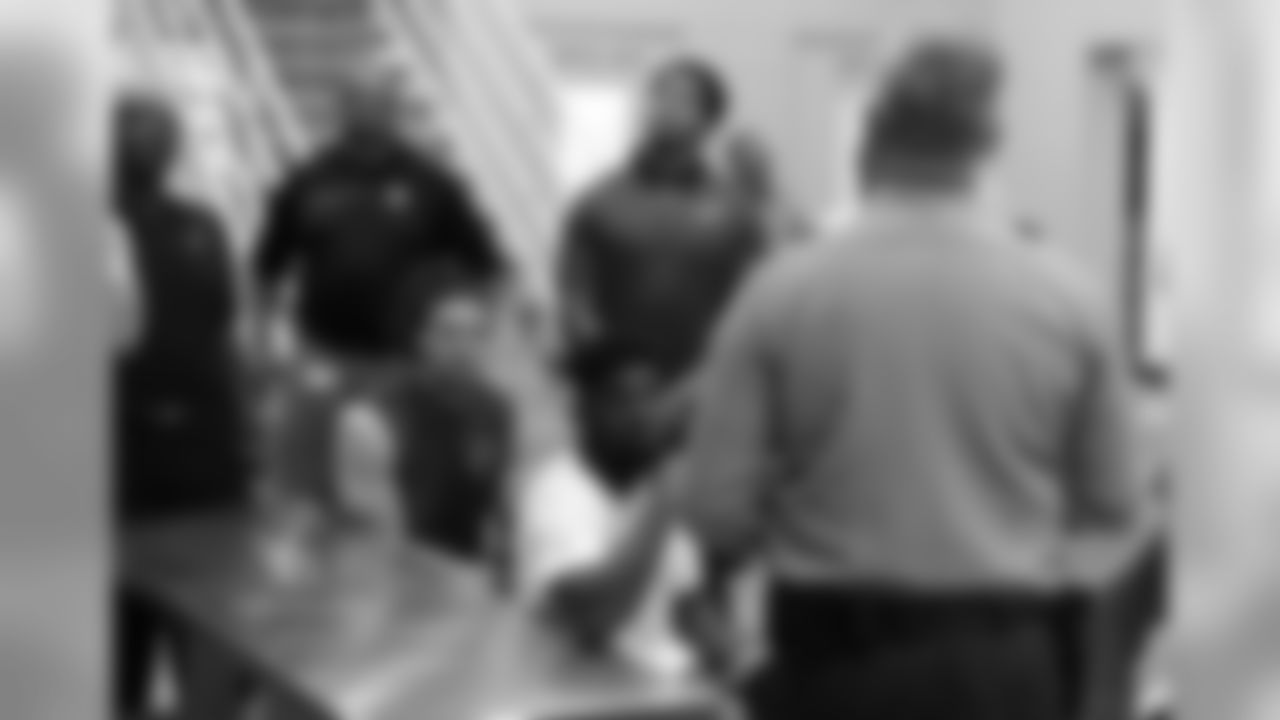 RB T.J. Logan (front) listens to information about the jail