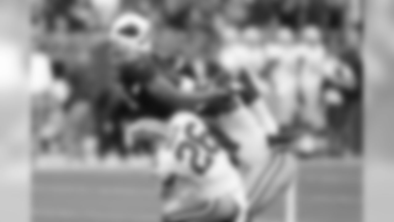 Floyd gets crunched by two 49ers defenders but holds on for the reception