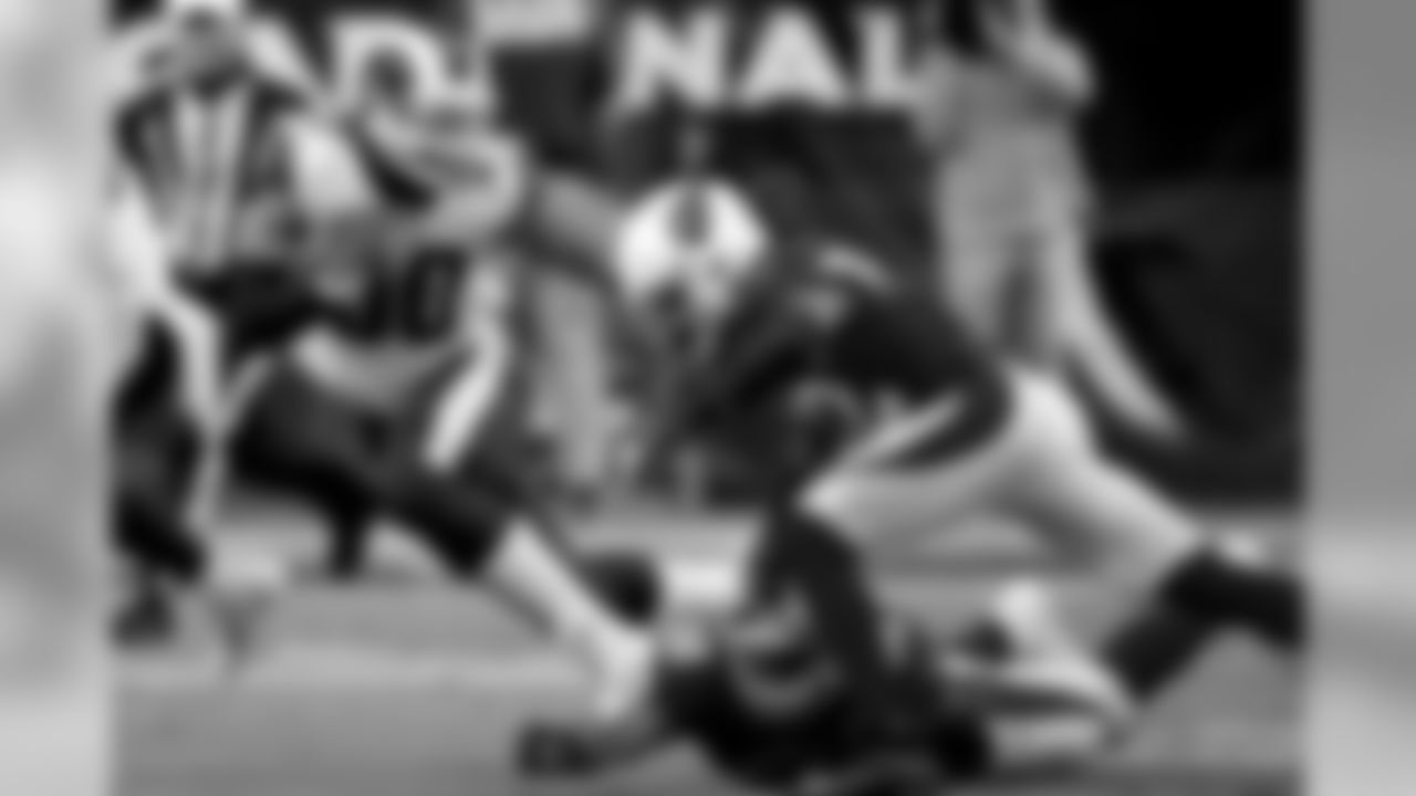 Rams running back Todd Gurley is tackled by Cardinals linebacker Jordan Hicks (58) and safety Budda Baker (32).