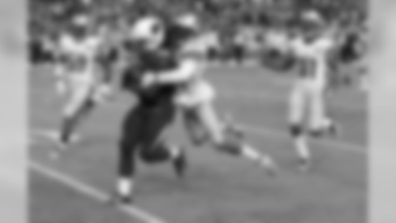 RB Robert Hughes is tackled by Lions CB Cassius Vaughn