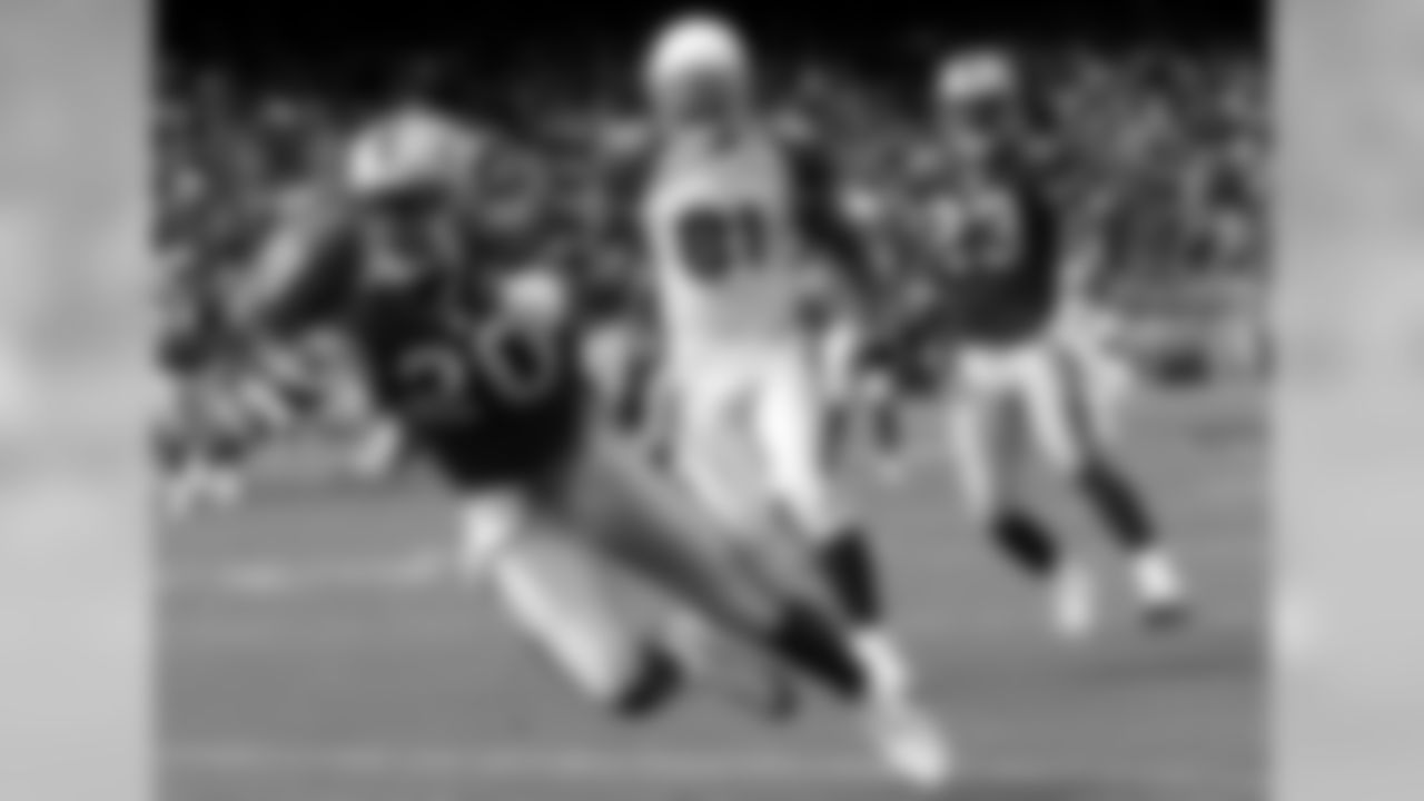San Francisco 49ers' Mke Adams, left, intercepts a pass intended for Arizona Cardinals' Anquan Boldin, center, during the second quarter in San Francisco on Sunday, Dec. 4, 2005. At right is 49ers' Derrick Johnson.