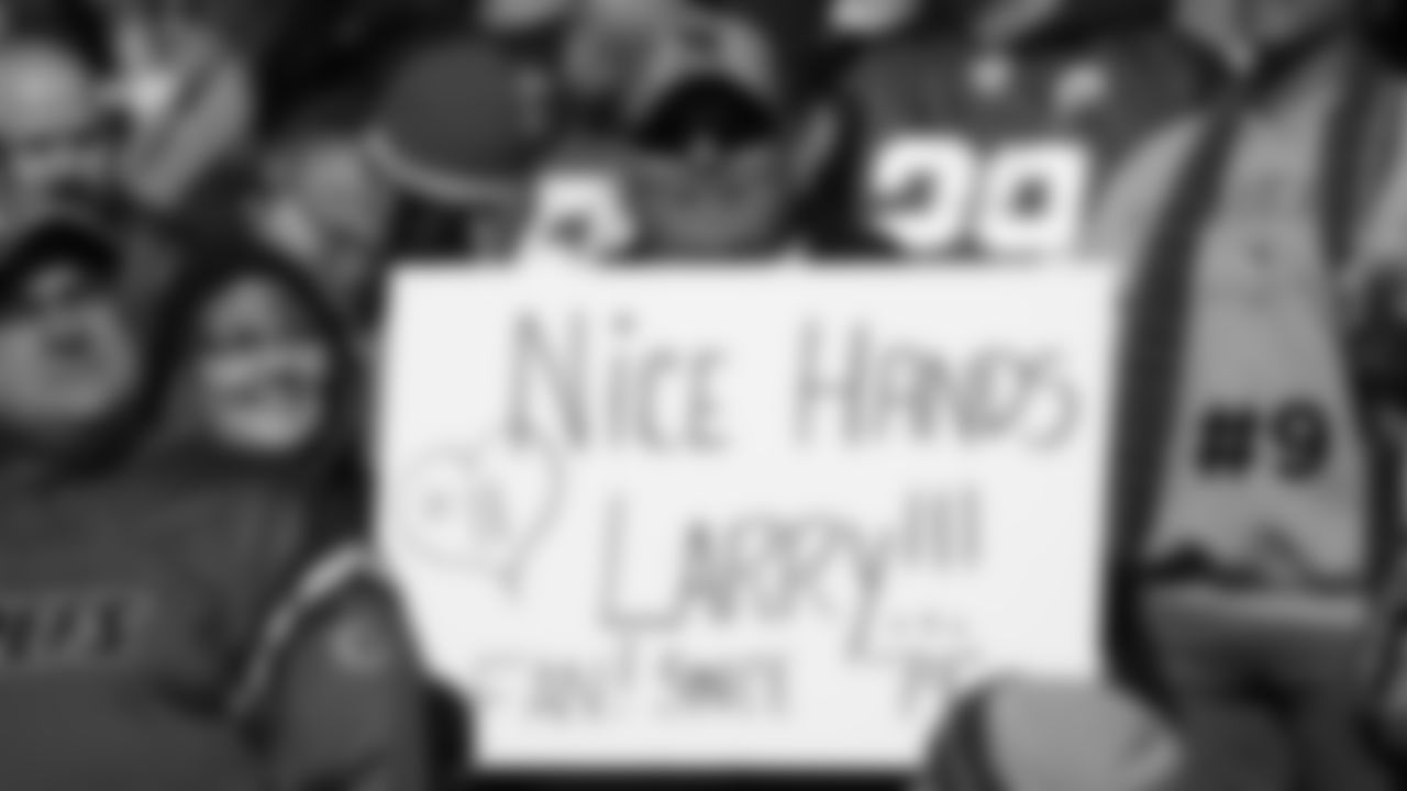 9. A Larry Fitzgerald fan holds up a sign in the stands