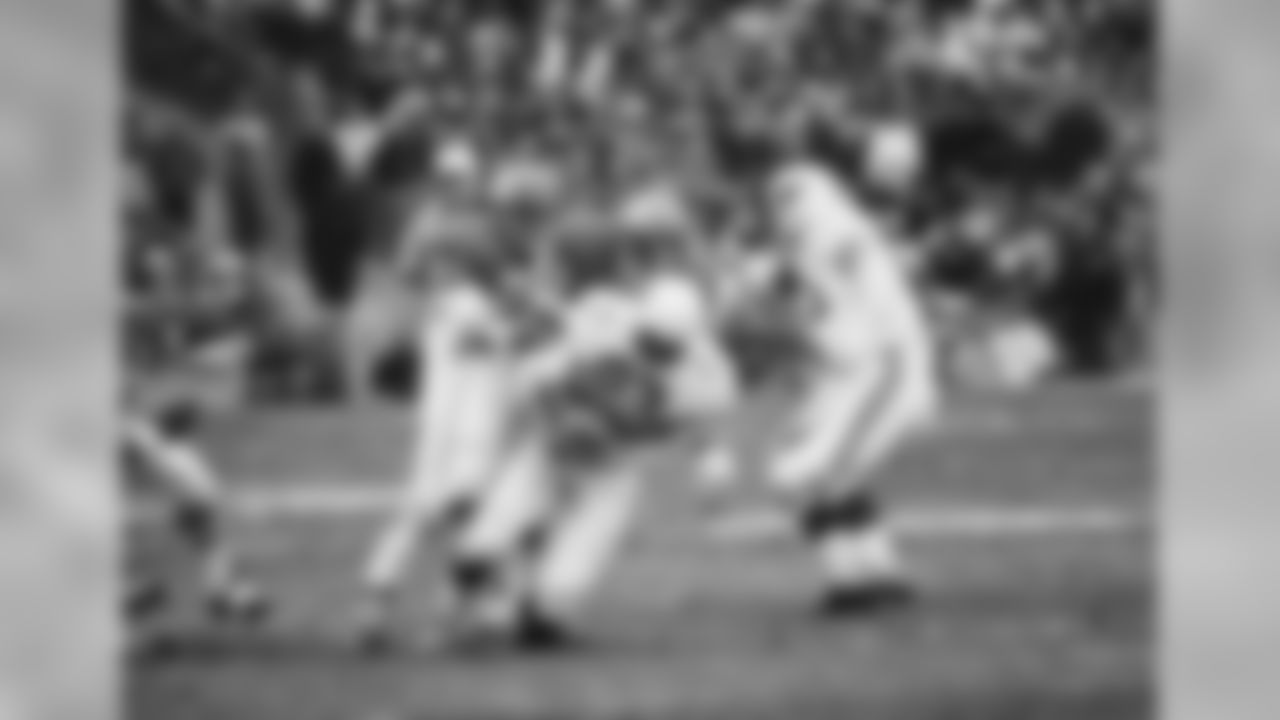 1970: RB John Roland is tackled by the Chiefs' George Daney