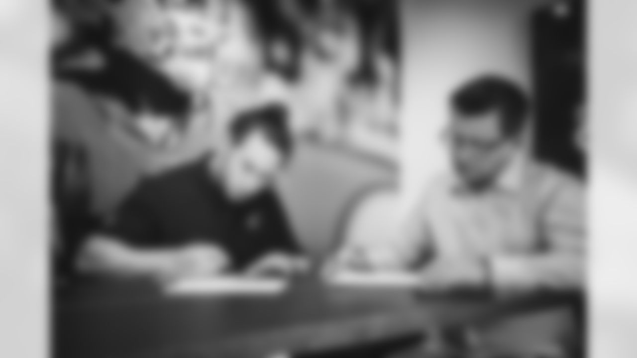 LB Dennis Gardeck and Cardinals owner Michael Bidwill begin to sign the contract.