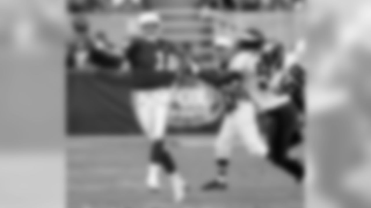 1999: QB Jake Plummer has his jersey grabbed by William Thomas
