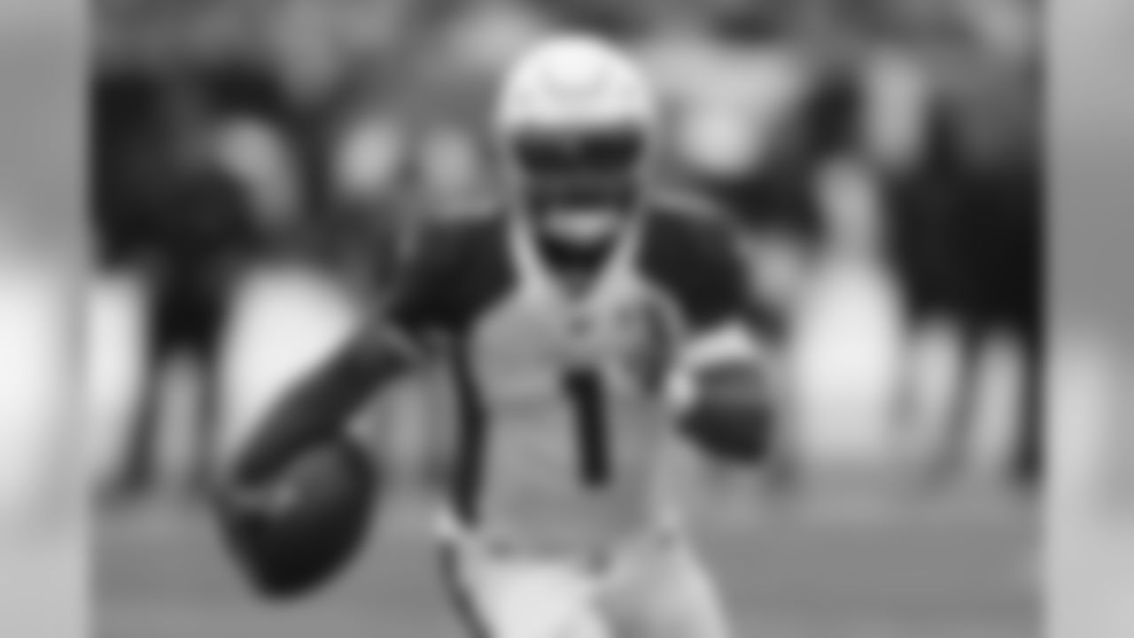 Cardinals quarterback Kyler Murray runs the ball in the first half.