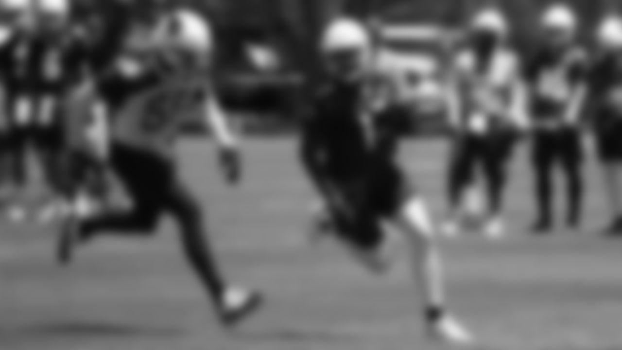 WR Jalen Tolliver (right) runs away from LB Edmond Robinson