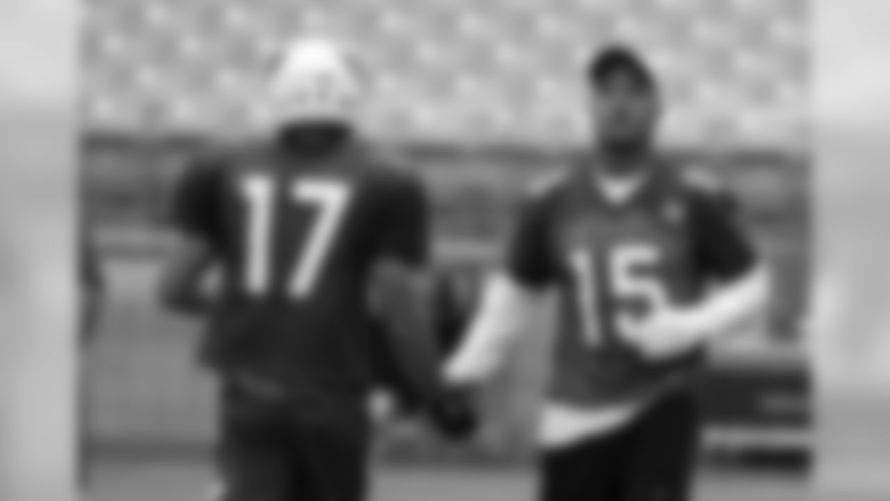 Michael Floyd (15) slaps hands with fellow WR Trevor Harman