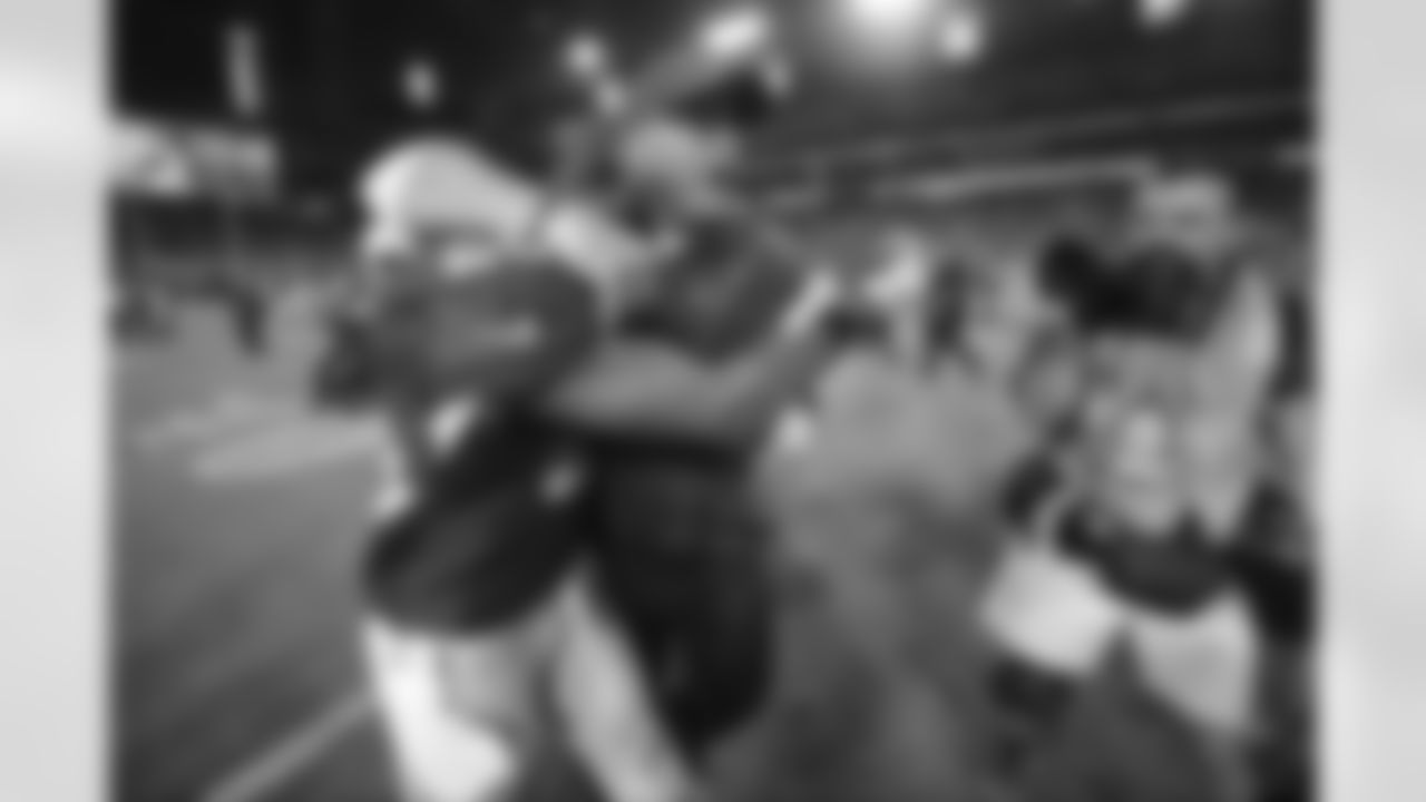 Coach Bruce Arians hugs S Rashad Johnson after the win over the Eagles