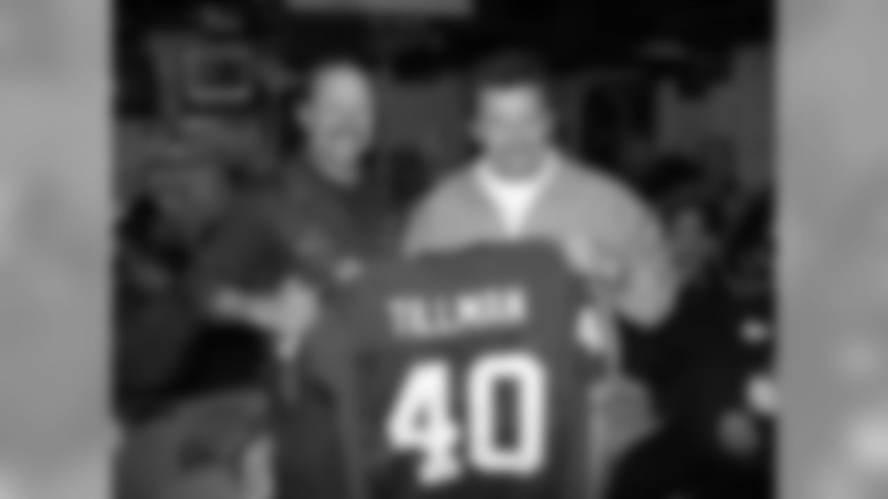 Michael Bidwill presents a Pat Tillman jersey to Nimitz captain Michael Man