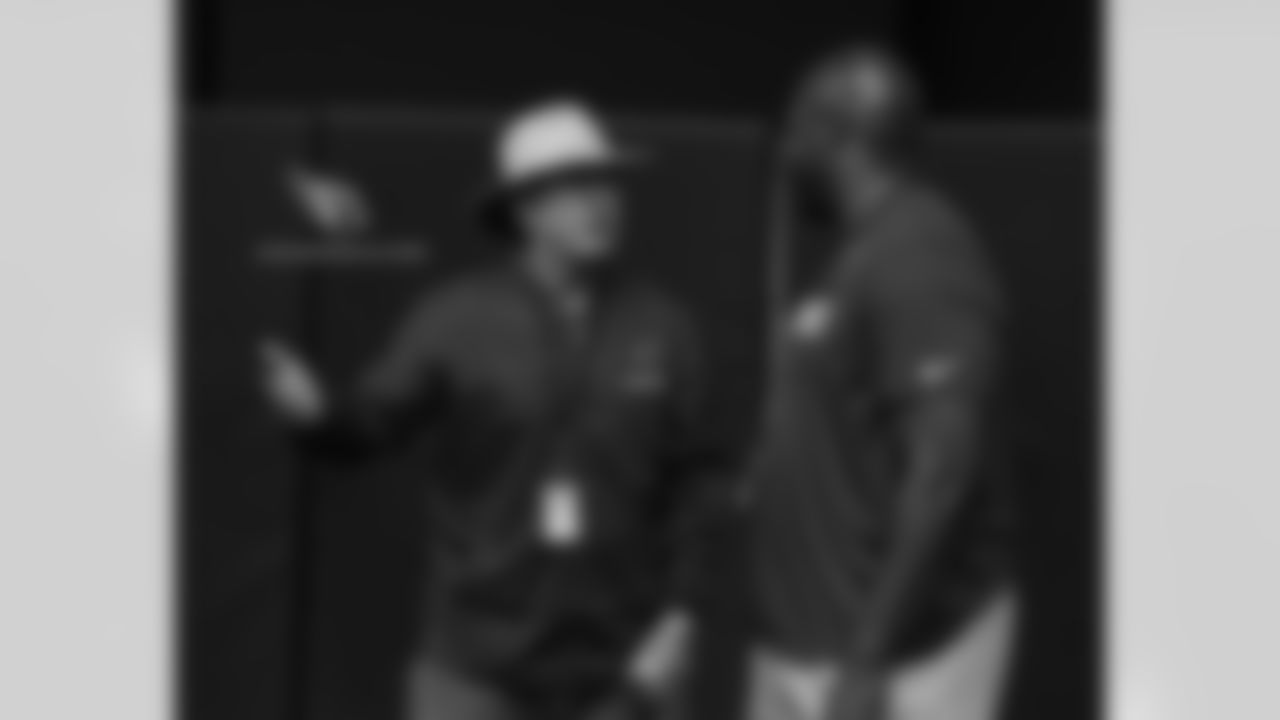 Former New York Giants coach Tom Coughlin, who works for the NFL, chats with former Cardinal Bertrand Berry at practice
