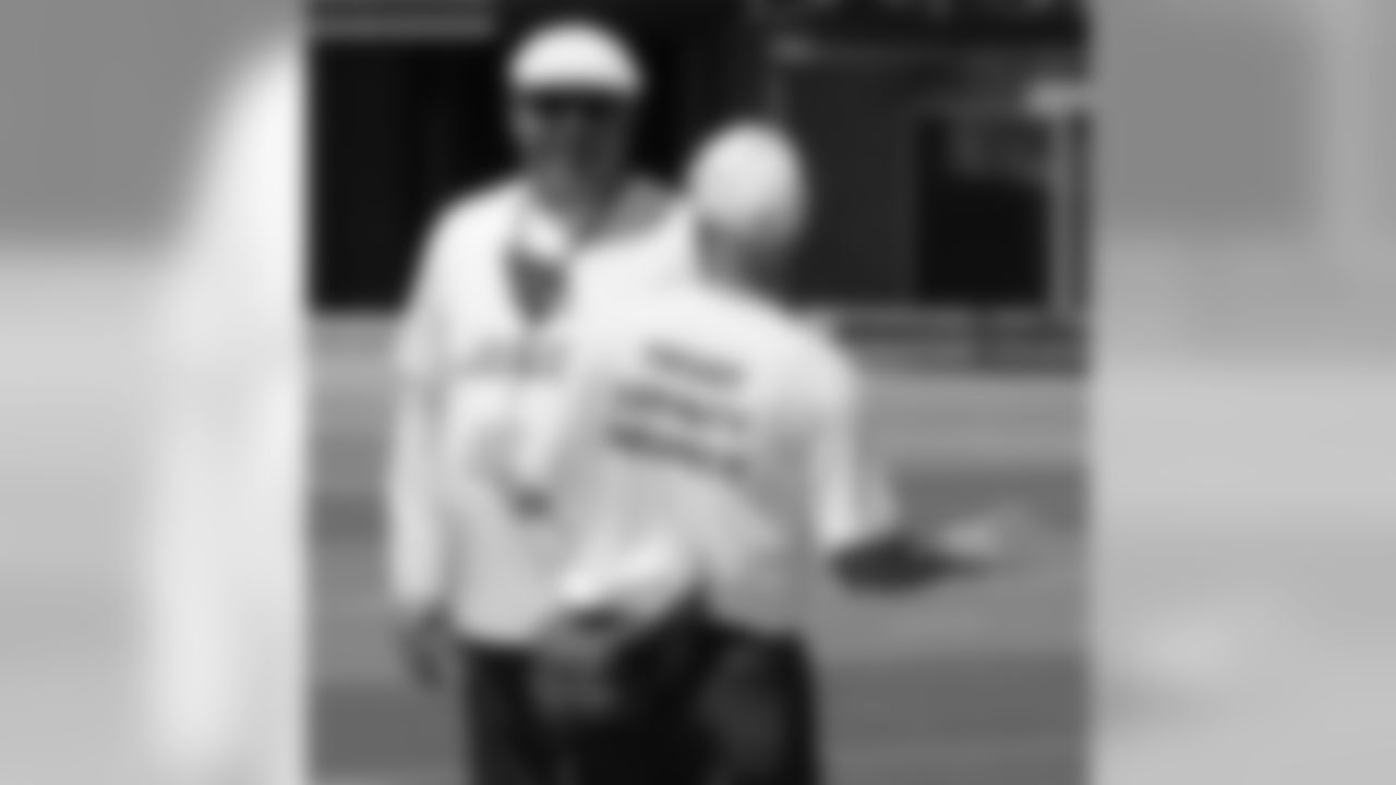 Coach Bruce Arians has a laugh with assistant equipment manager Steve Christensen