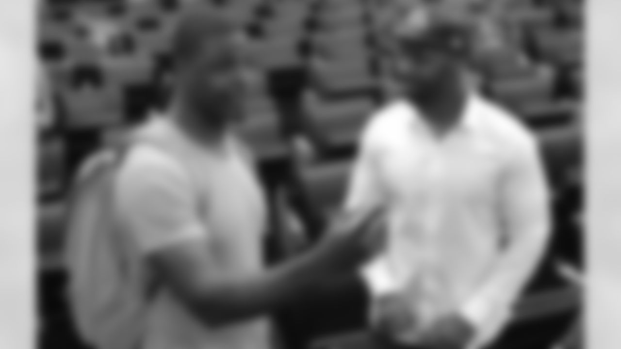 Cardinals scout Adrian Wilson talks with Reddick's father, Raymond Matthew