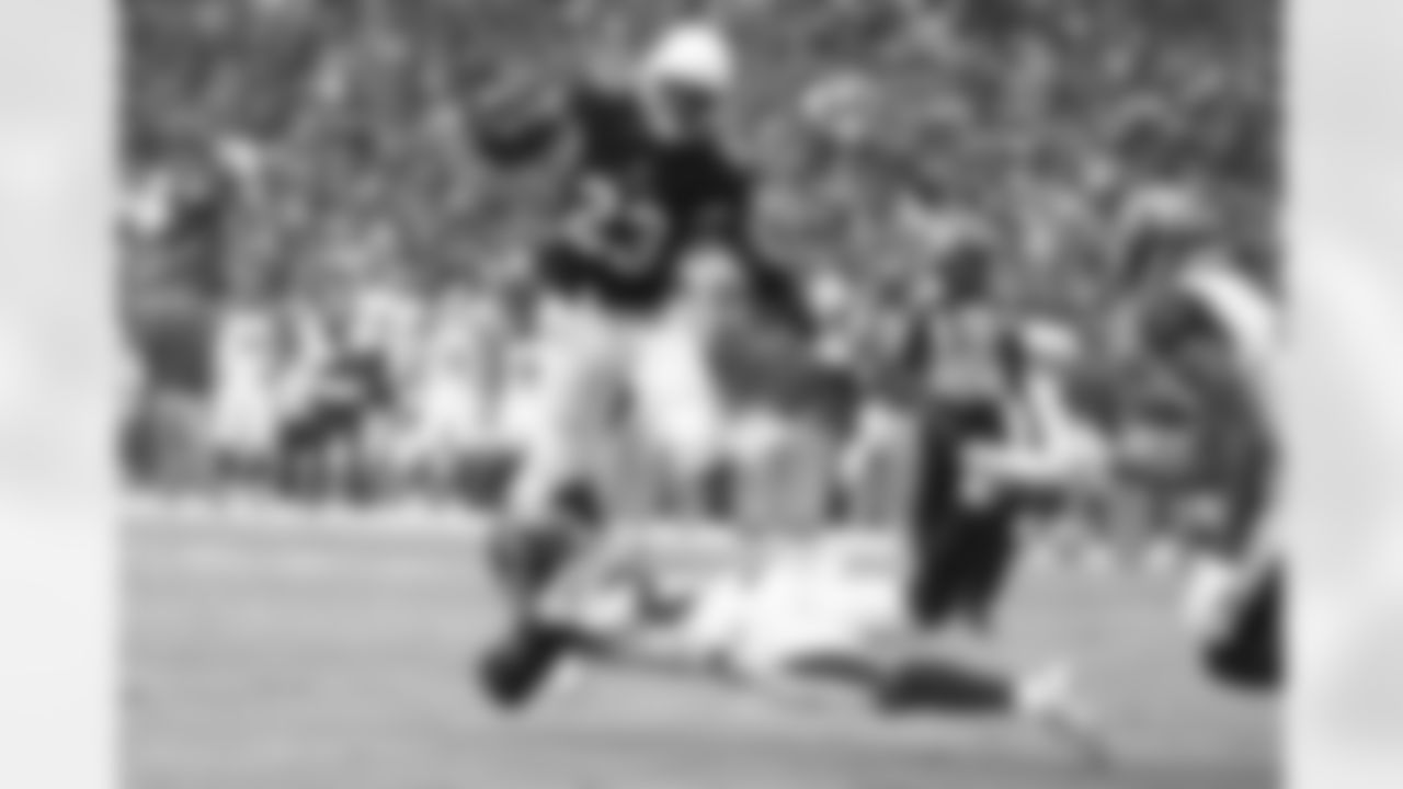 RB Adrian Peterson leaps over a Tampa Bay defender