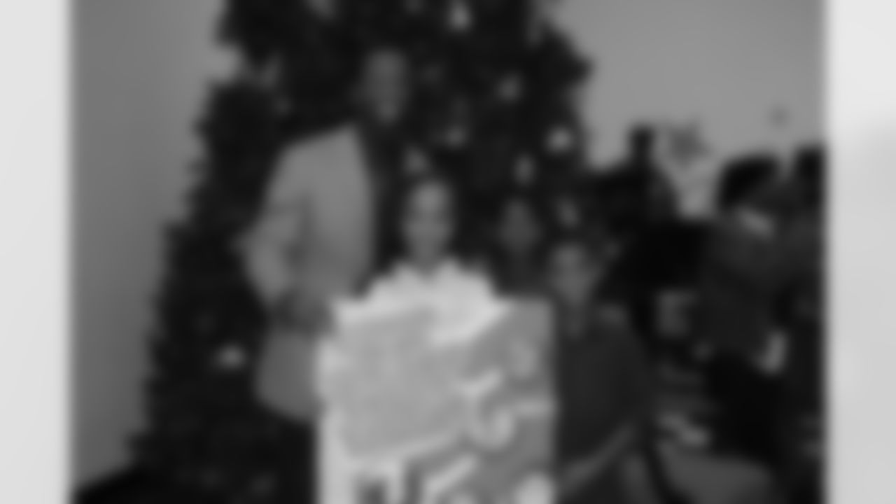 Larry Fitzgerald takes a picture after receiving a giant Christmas card.