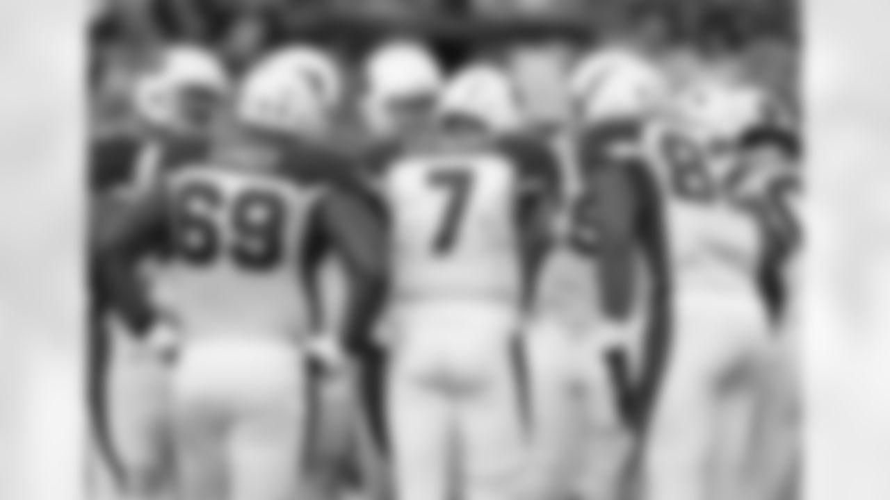 Cardinals first string offense huddles before a play