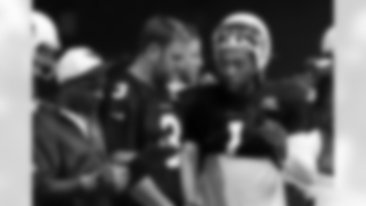 QB Carson Palmer (left) talking with QB Phillip Sims