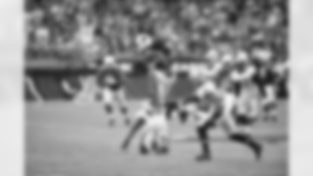 WR Larry Fitzgerald hurdles a Saints defender
