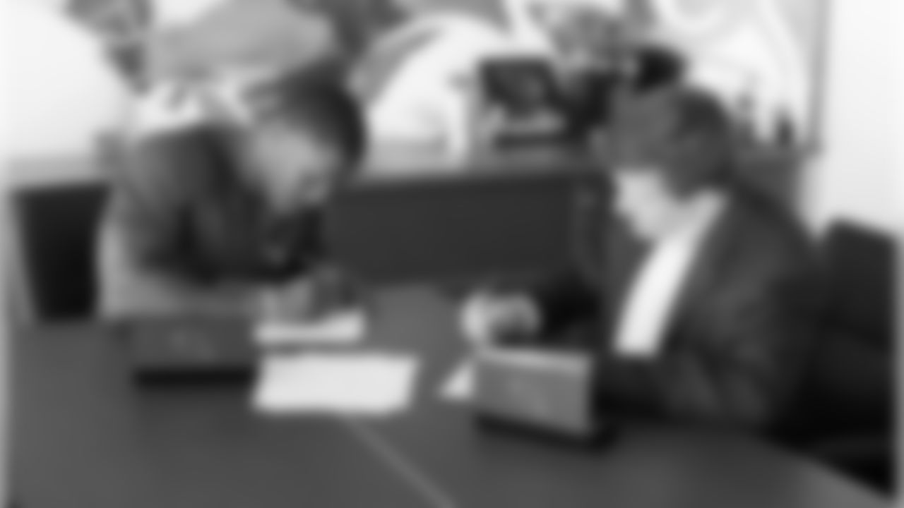 RB David Johnson signs his contract next to team president Michael Bidwill