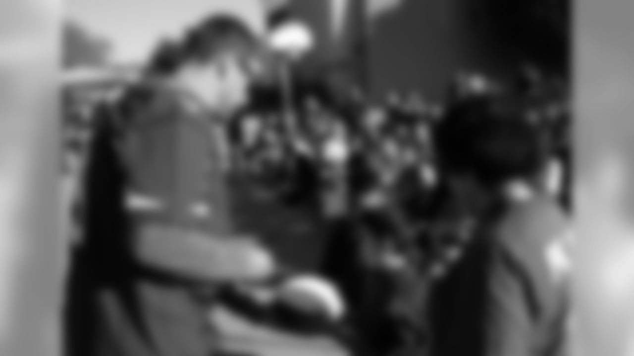 QB Carson Palmer signs an autograph for a young fan