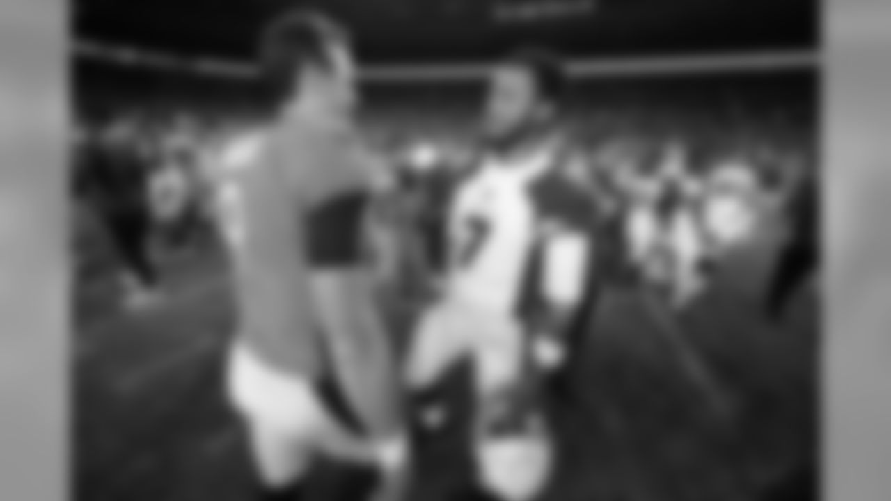 Denver Broncos quarterback Kevin Hogan (9) greets Arizona Cardinals quarterback Brett Hundley after an NFL preseason football game.