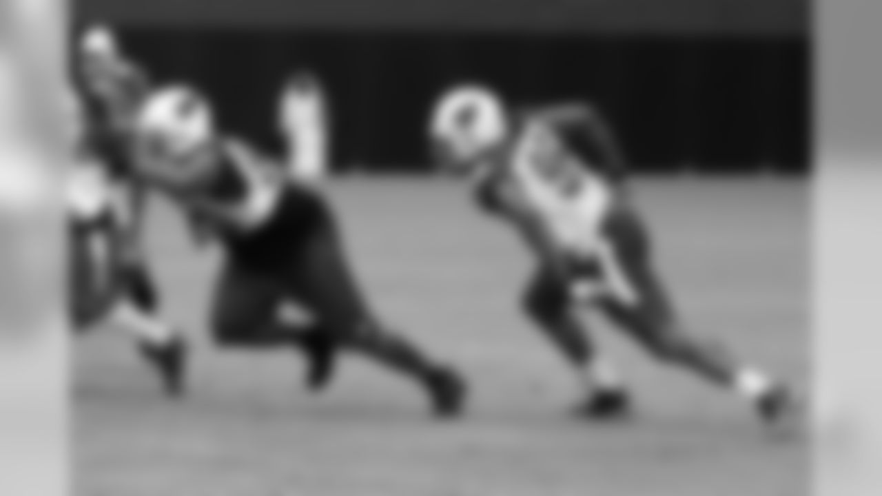 The defensive linemen charge after the snap