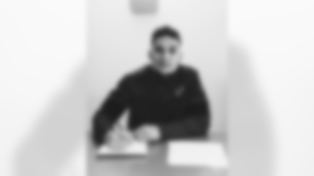 Images of veteran running back James Conner signing his one-year contract on Tuesday.
