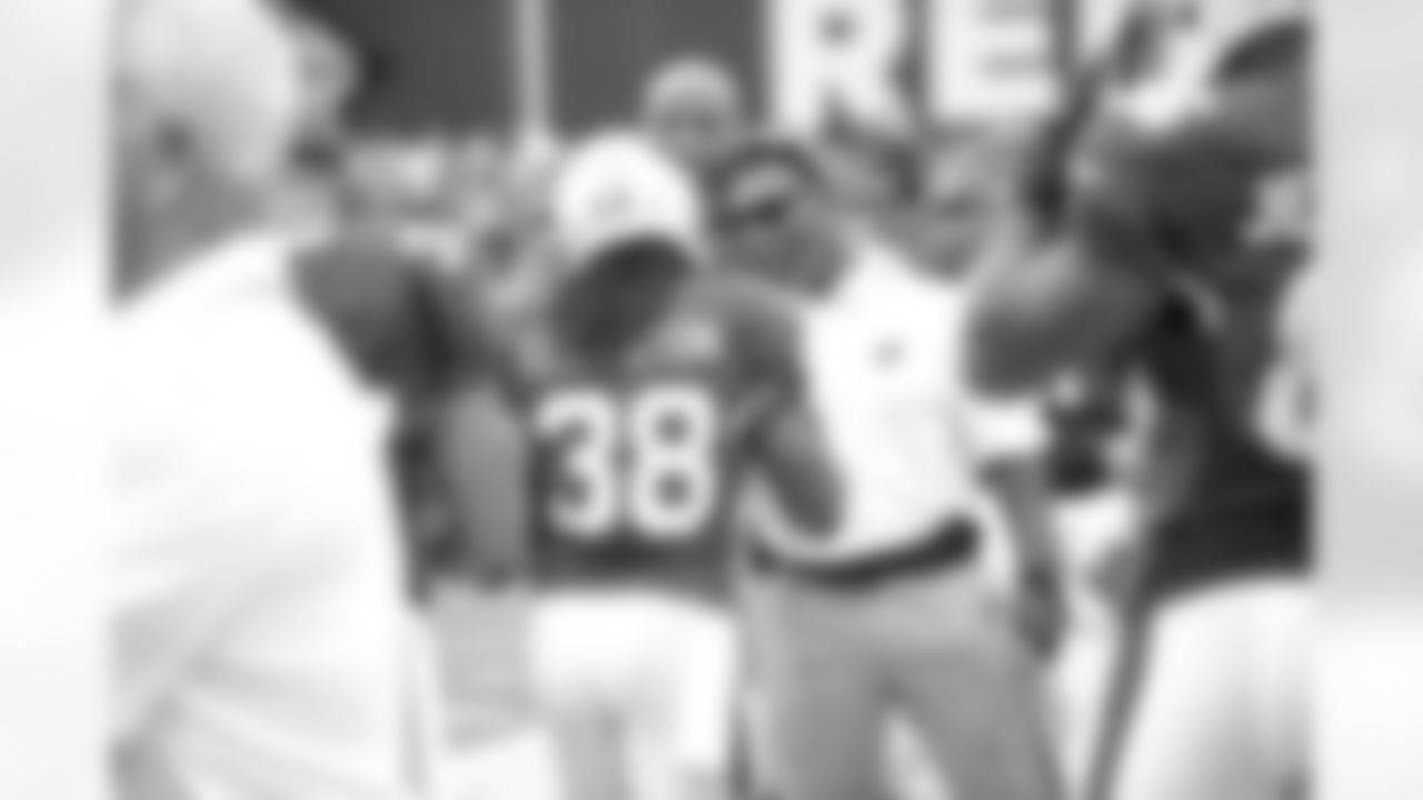 Running backs coach Stump Mitchell congratulates RB Andre Ellington after a touchdown