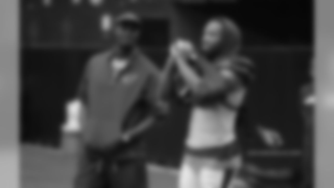 Coaching intern Plaxico Burress and WR Larry Fitzgerald