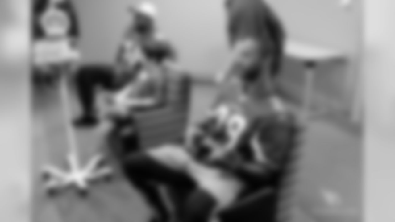 CB Justin Bethel (right) and LB Gabe Martin play video games with a patient