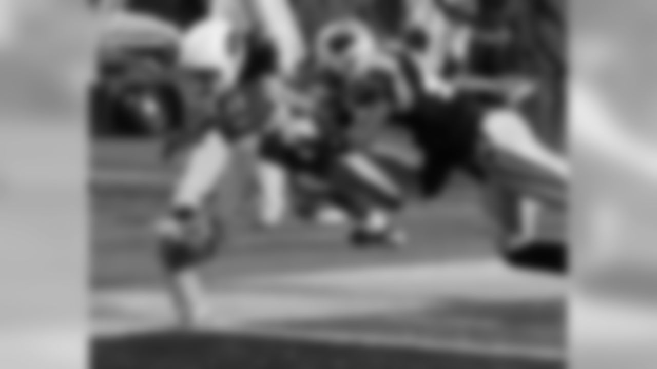 WR Larry Fitzgerald reaches the ball over the goal line for a touchdown as Panthers' Chris Harris defends.