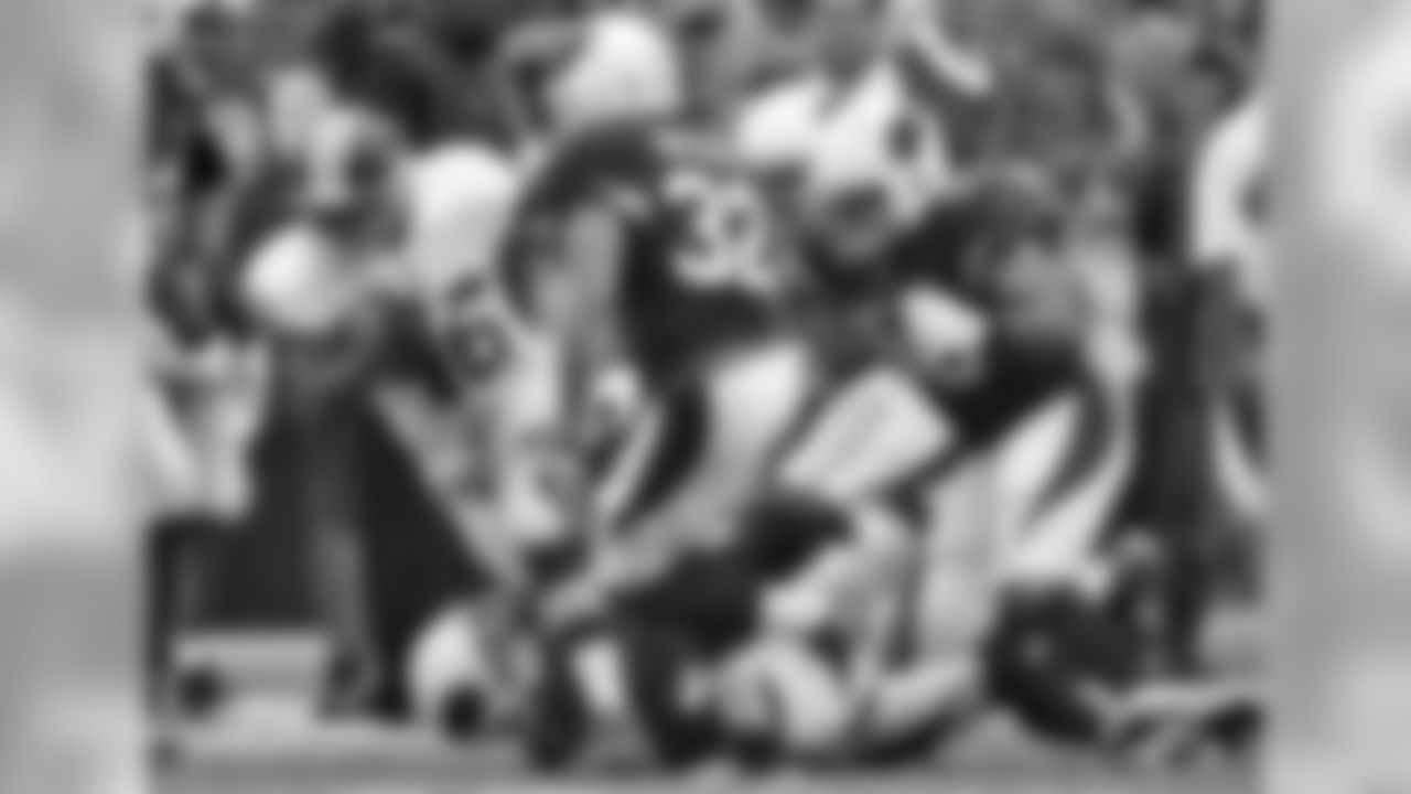 RB Alfred Morris rushes as S Tyrann Mathieu closes in