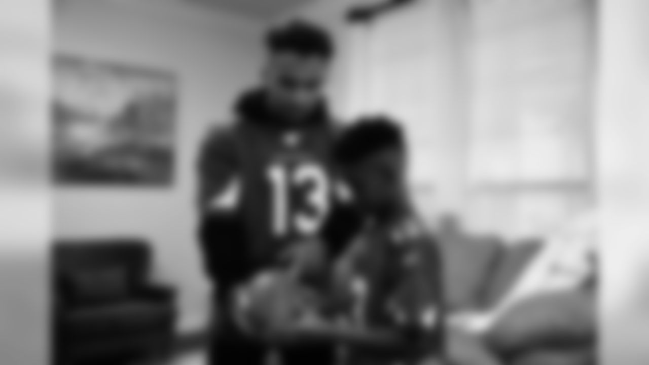 Images of Cardinals receiver Christian Kirk delivering surprise Super Bowl tickets to Devin Manigo at his home in Texas