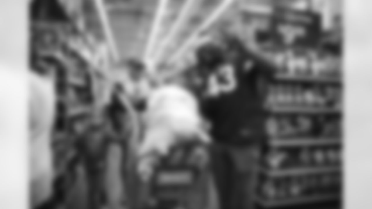 The Arizona Cardinals participate in Shop With A Jock with Desert Financial Credit Union at Walmart on Tuesday, December 13, 2022 in Tempe, AZ.