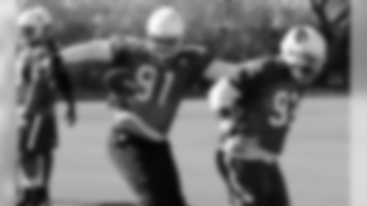 LB Matt Shaughnessy practices stripping the ball from DT Frostee Rucker