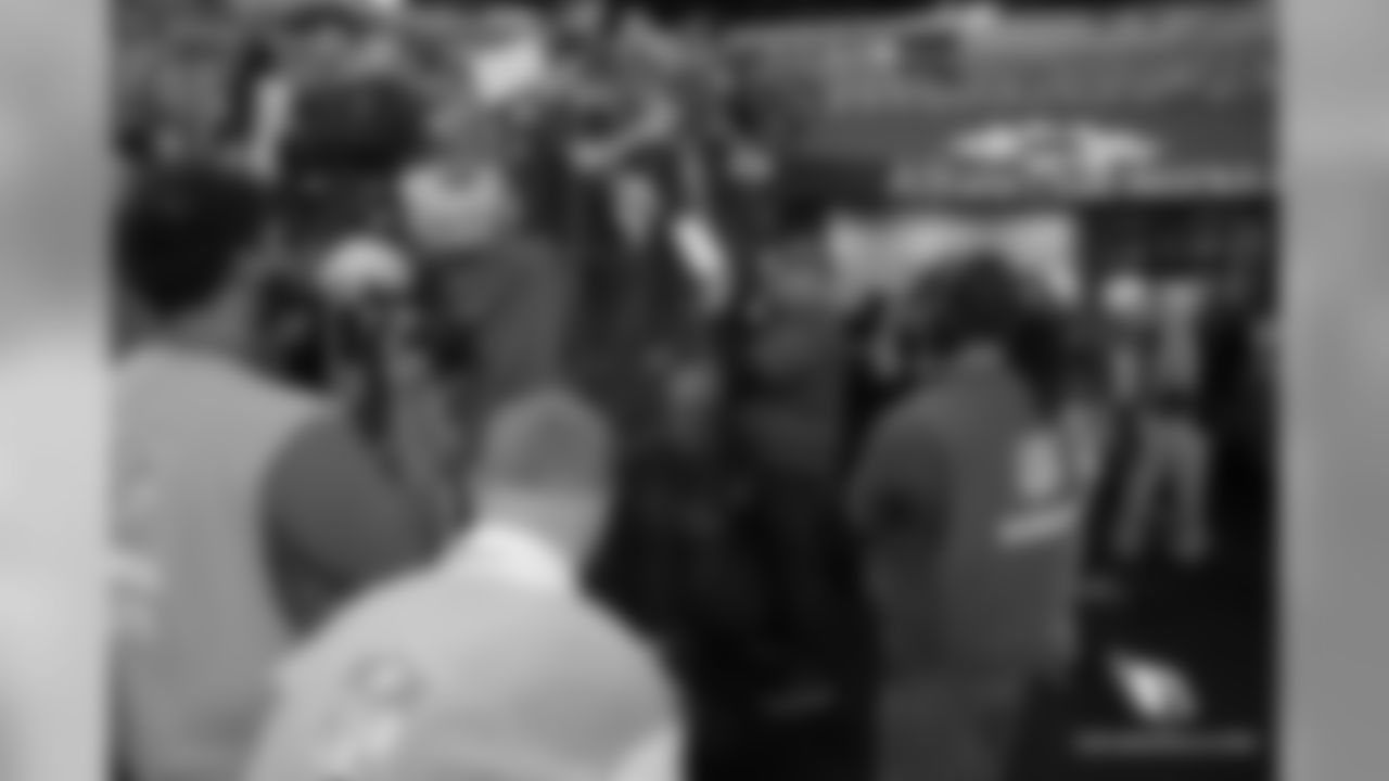 Coach Bruce Arians signs autographs before the game