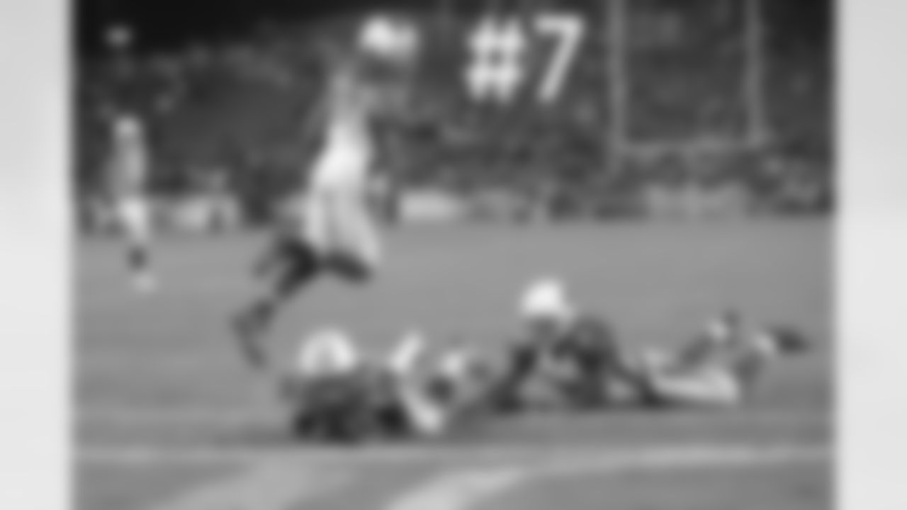 Titans WR Michael Preston dives into the end zone as S Yeremiah Bell jumps over him.