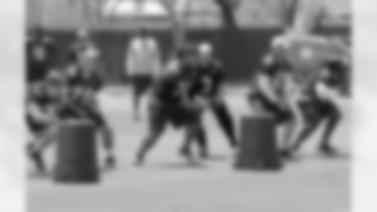 The first-unit offensive line heads out at the snap