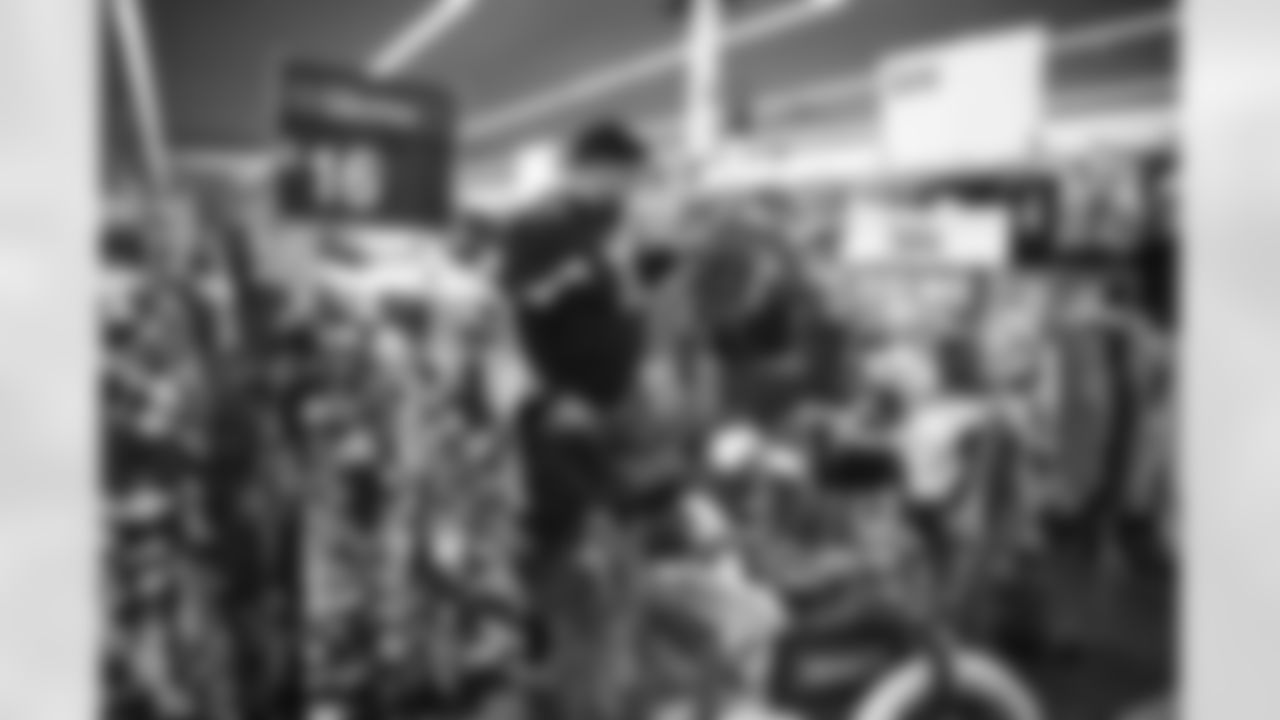 The Arizona Cardinals participate in Shop With A Jock with Desert Financial Credit Union at Walmart on Tuesday, December 13, 2022 in Tempe, AZ.