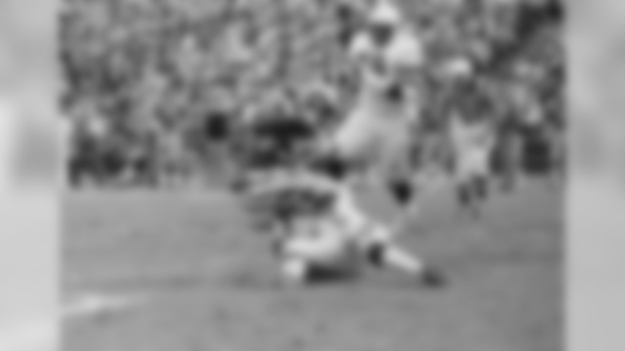 A St. Louis Cardinals defender tackles Los Angeles back Lawrence McCutcheon (30) after a 15 yard gain during action in game on Saturday, Dec. 27, 1975 in Los Angeles. McCutcheon gained 202 yards on 37 carries as the Rams won 35-23. In the background is Charlie Davis of the Cardinals.