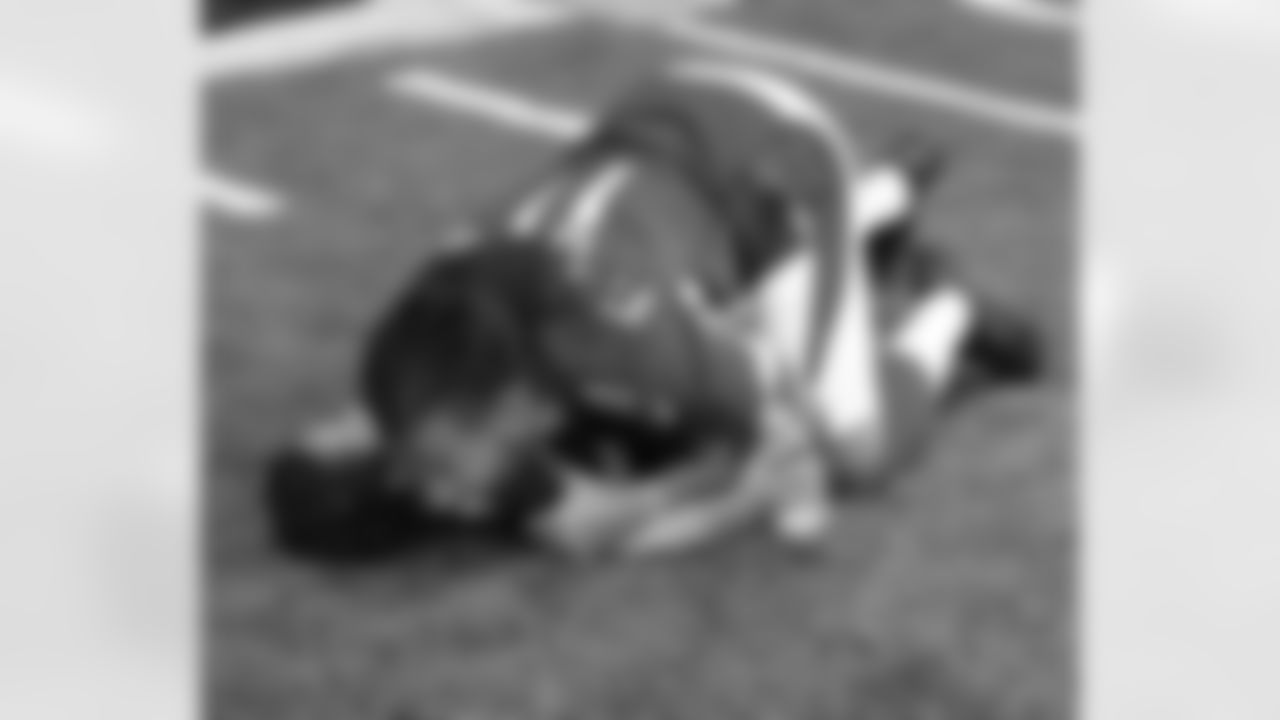 WR Larry Fitzgerald tackles his son Devin during a break