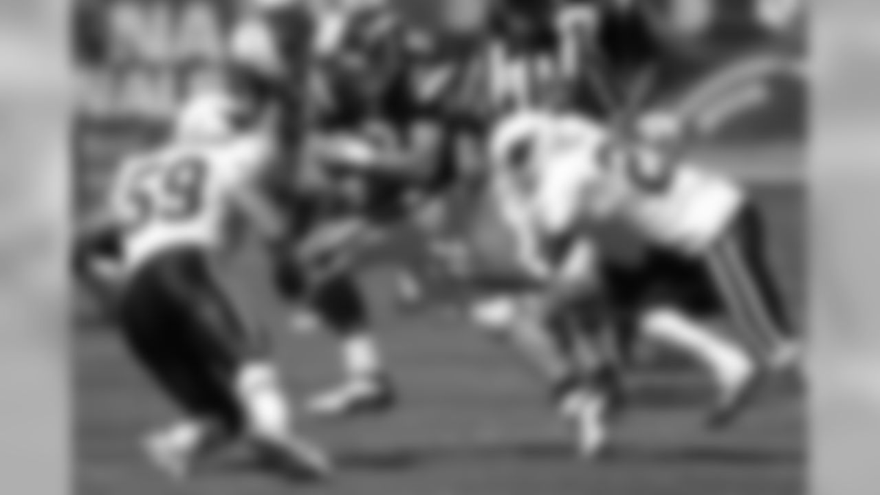 Rob Fredrickson (left) and Renaldo Hill close in on Chargers QB Drew Brees in 2002
