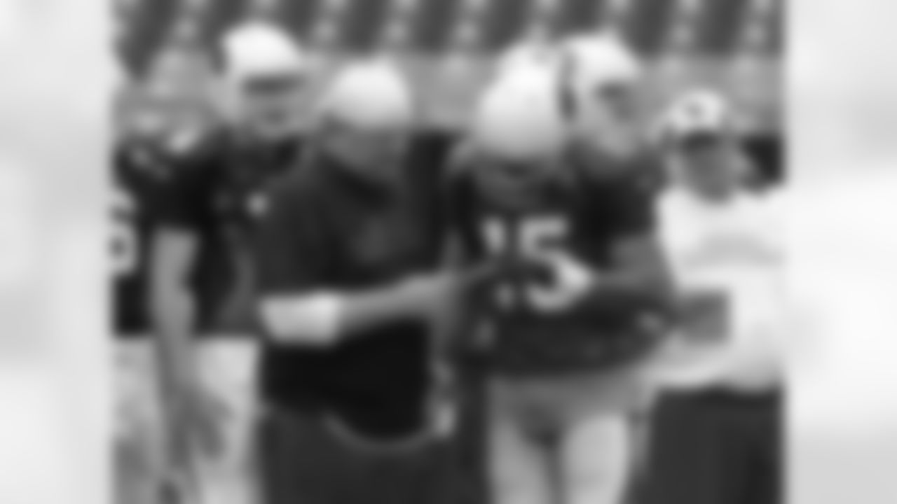 QB coach Freddie Kitchens helps WR Michael Floyd