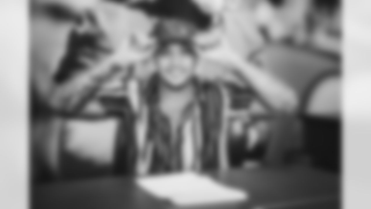 RB James Conner smiles during the contract signing.