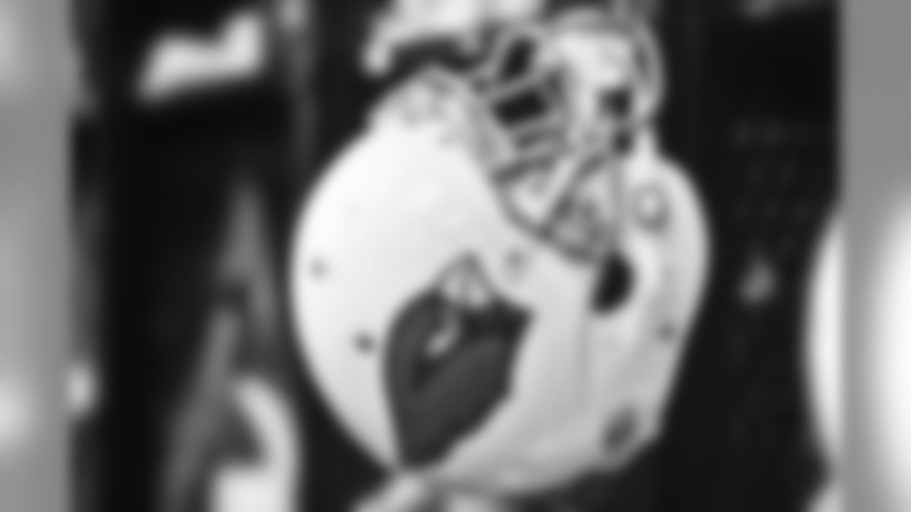 A helmet hangs in the locker room