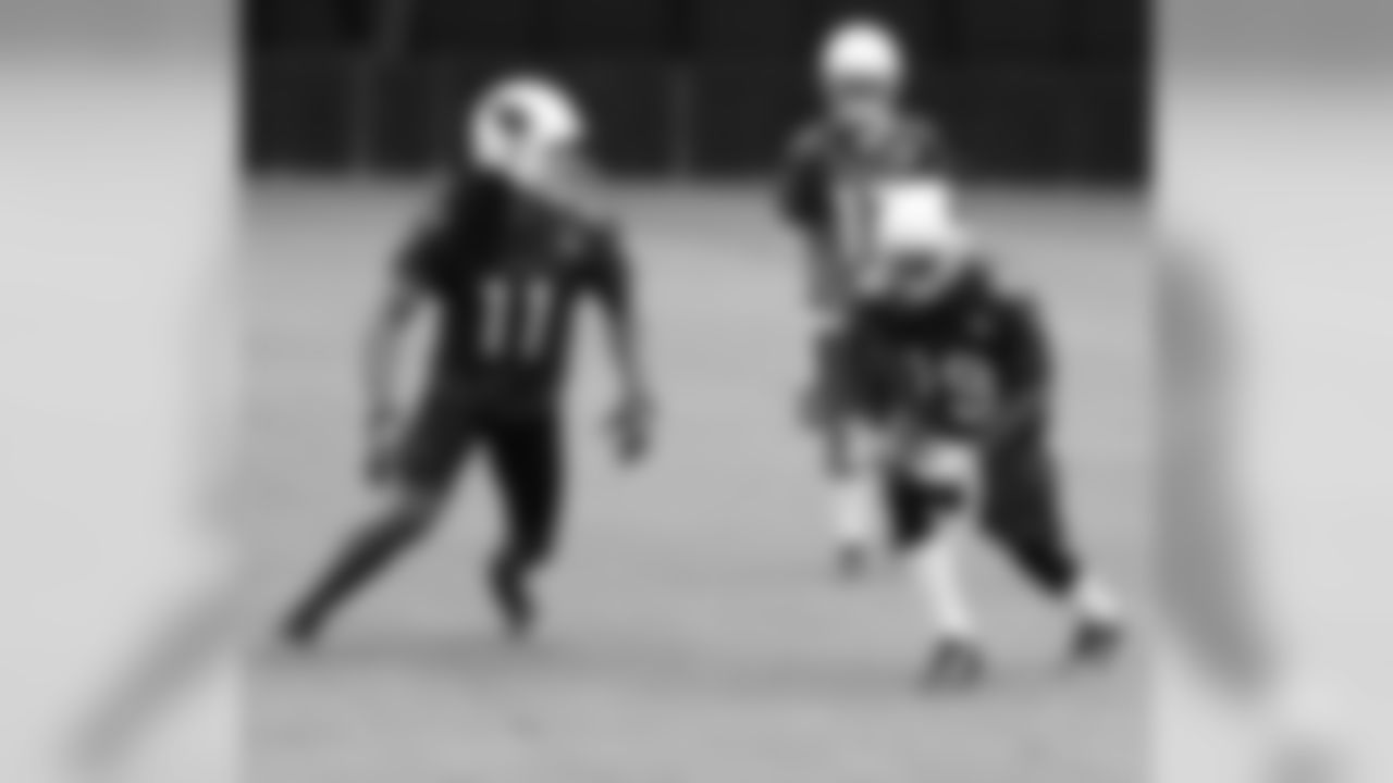 WR Larry Fitzgerald (left) prepares to cross WR Ted Ginn