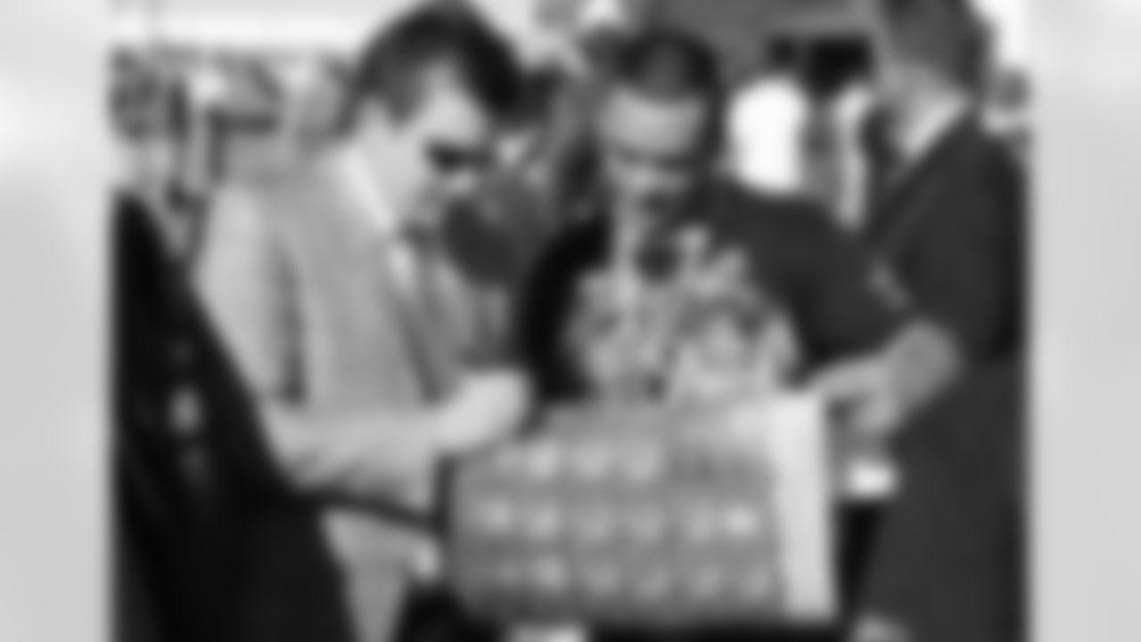 Michael Bidwill signs an autograph