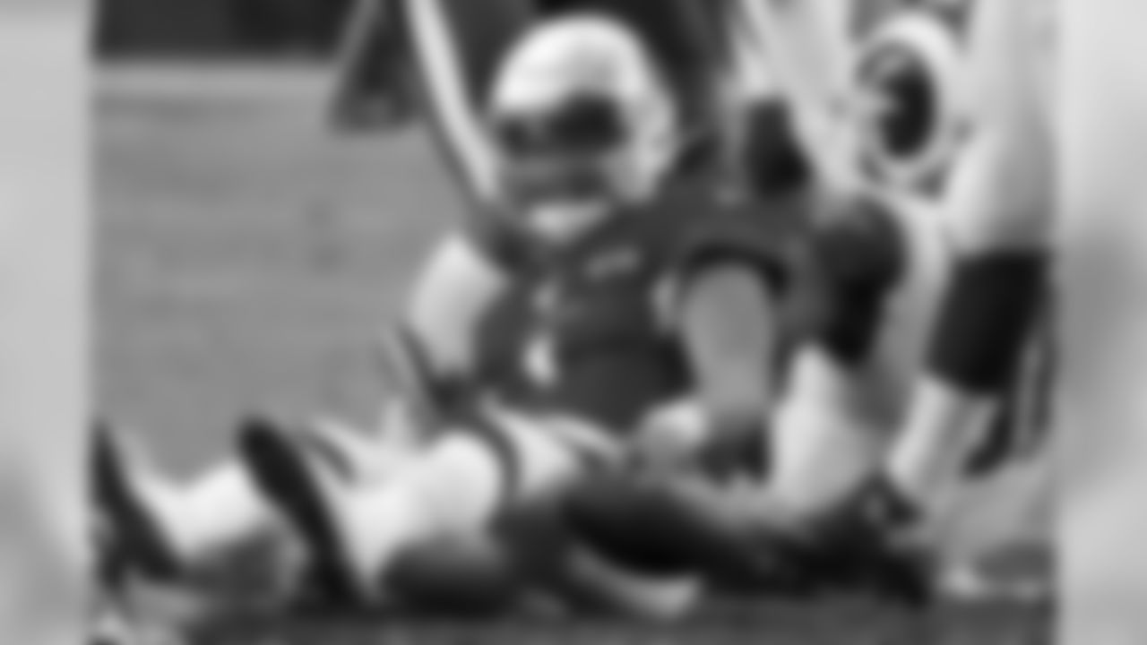 Cardinals quarterback Kyler Murray sits on the turf after being sacked against the Los Angeles Rams.
