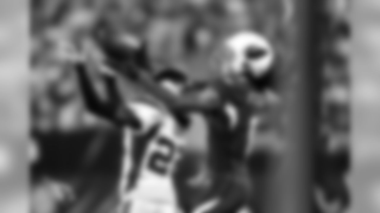 WR Larry Fitzgerald makes a catch over a Vikings defender.